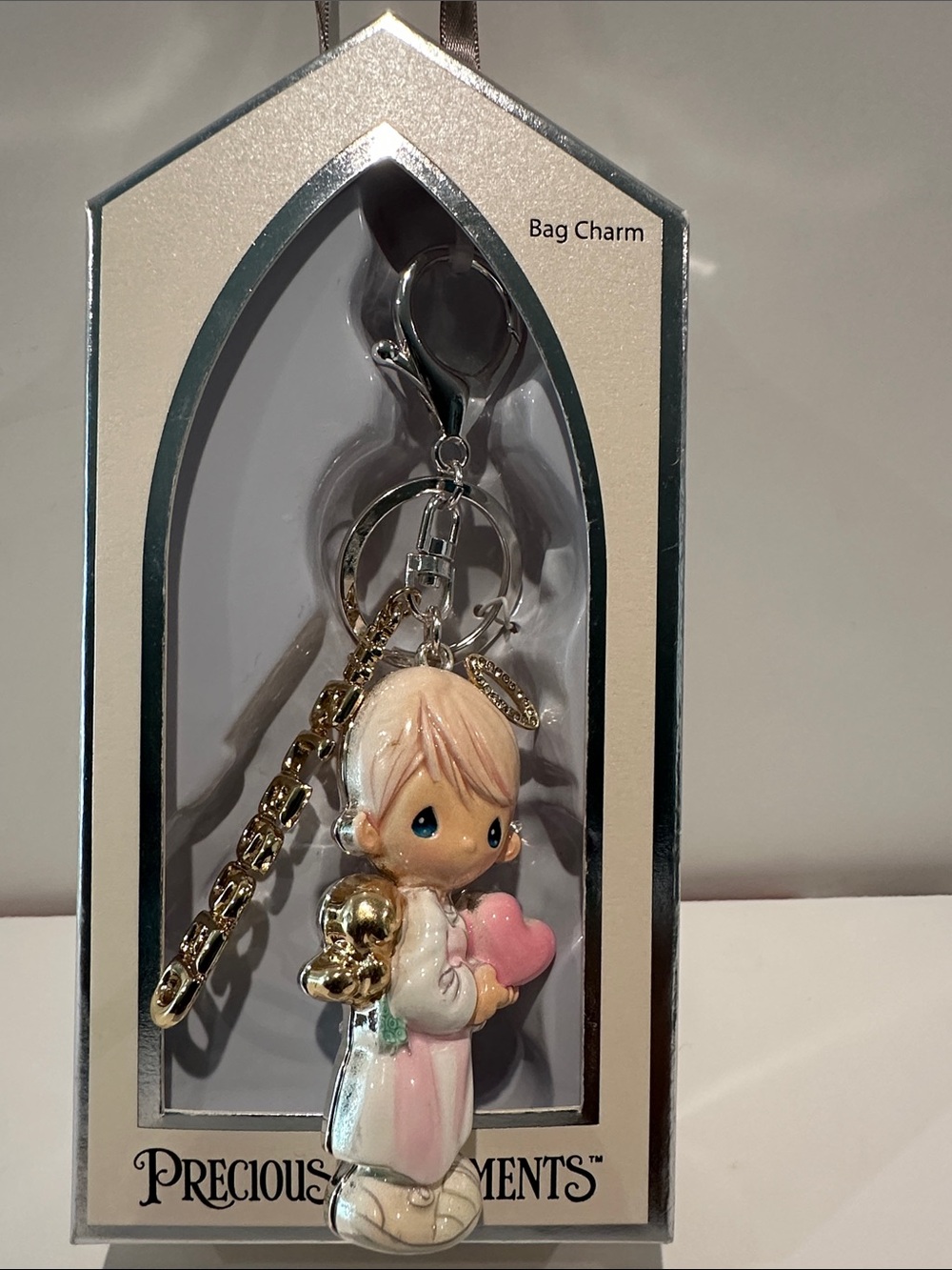 Precious Moments Blessed Bag Charm in Goldtone and Silvertone colors.